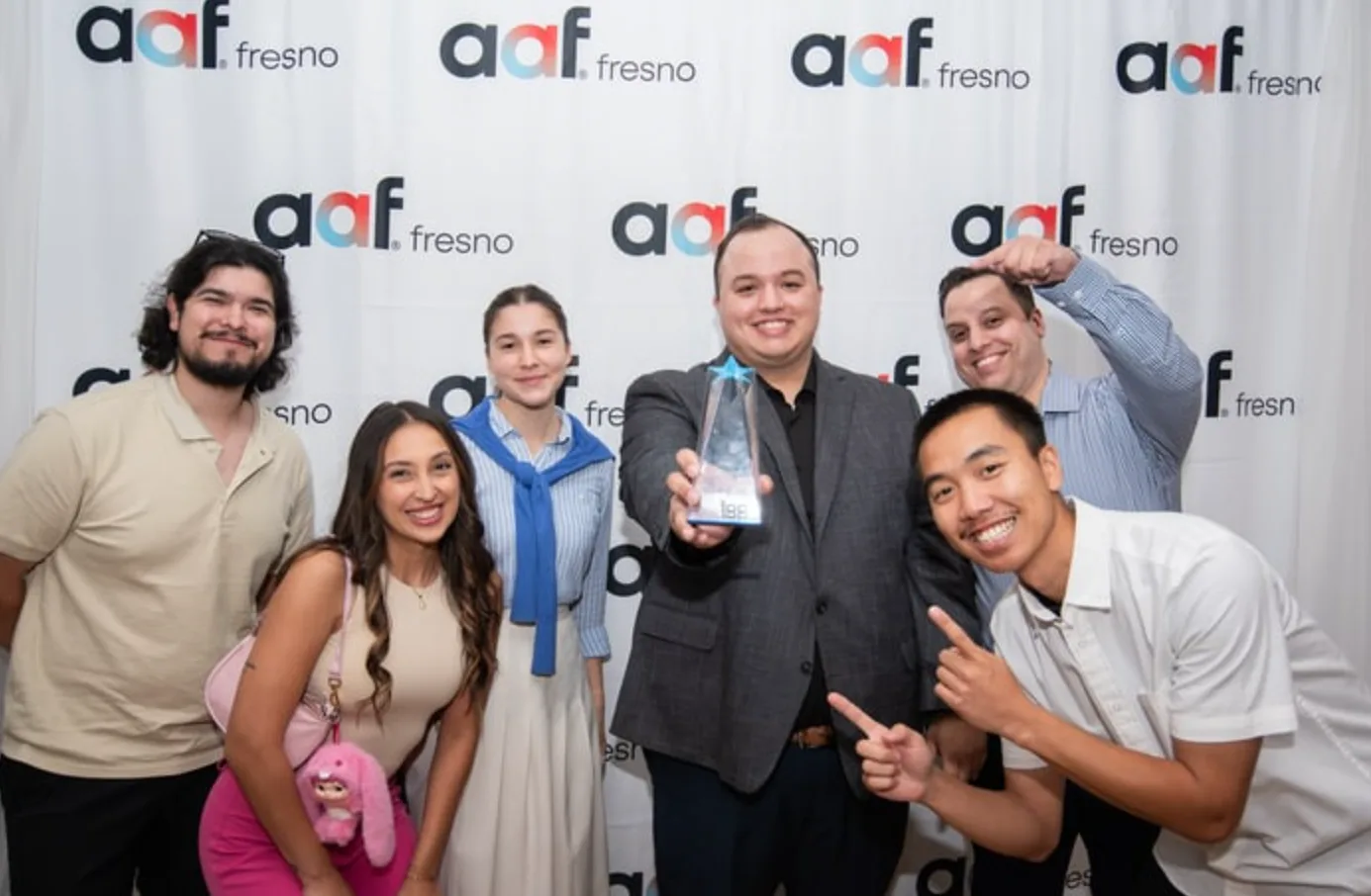 The AMARQUEZ team celebrating with their award at AAF Fresno.